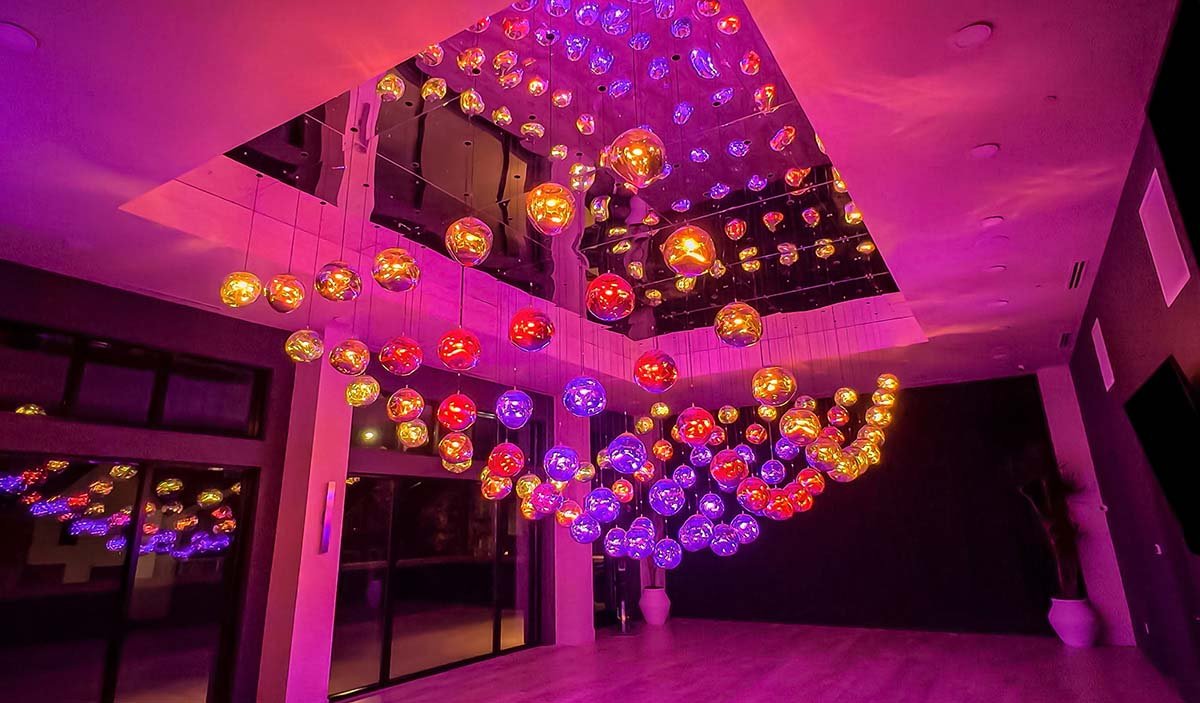 Interactive kinetic light sculpture made of illuminated glass spheres, an art installation for modern interiors.